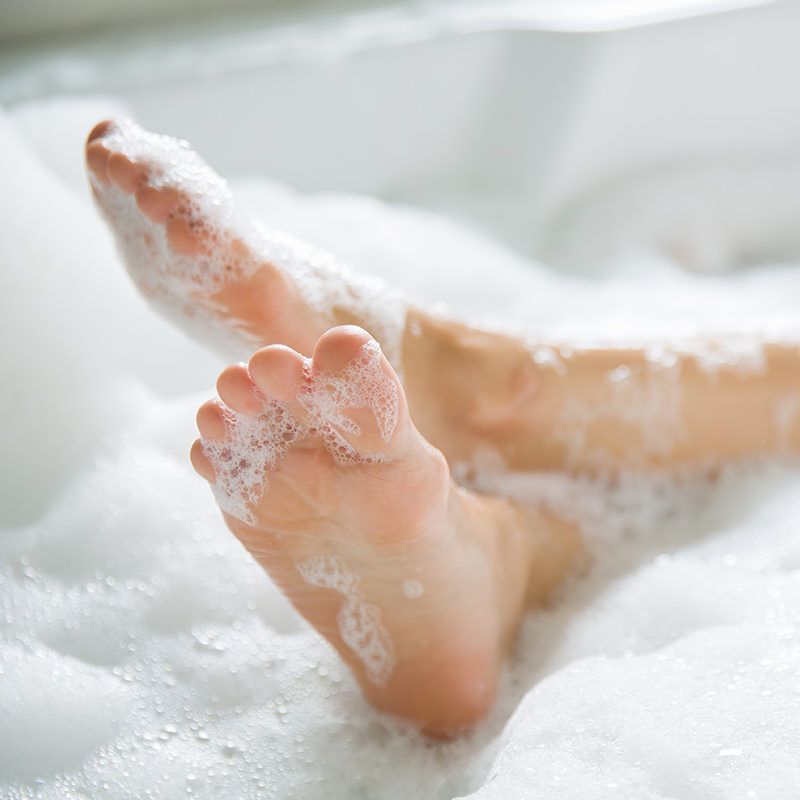 Person with Legs Crossed in Bath